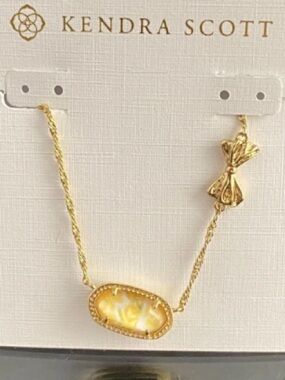 Brand new with tags, yellow flower bow gold necklace